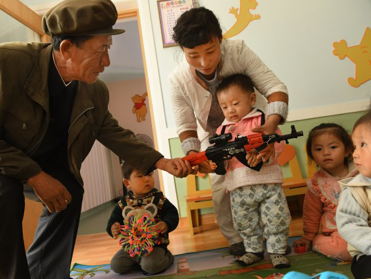 north korean toddler in nursery school with gun
